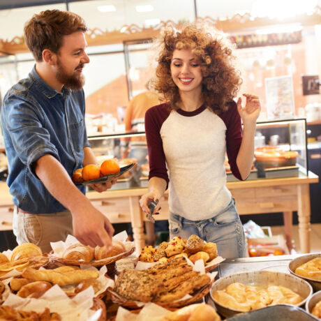 Young salesgirl service male customer